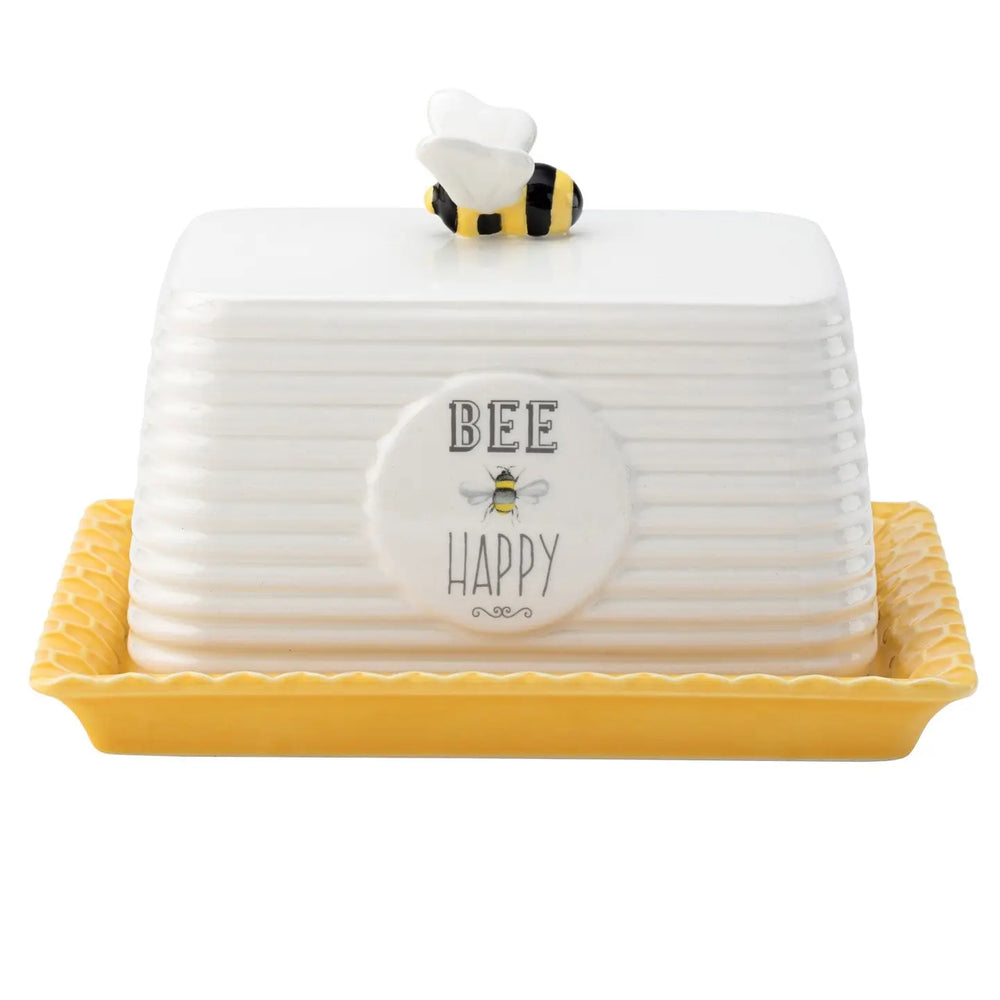 A ceramic white butter dish with the words Bee Mine on the front and a ceramic bee on the top