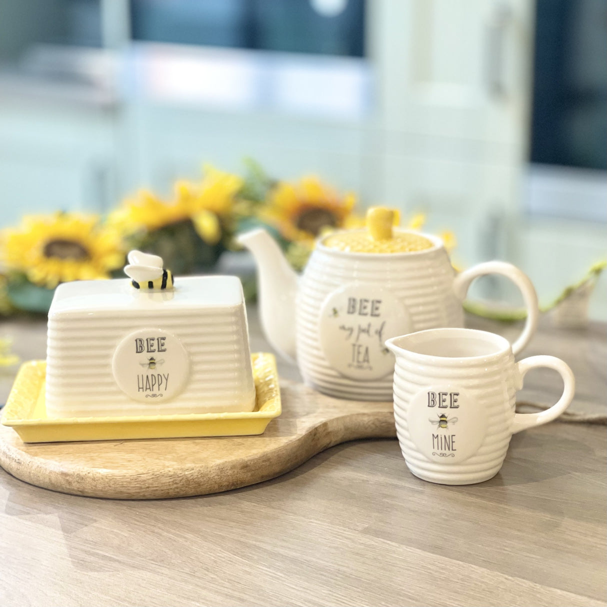 A collection of Bee inspired ceramics including a Teapot, Butter Dish and Creamer Jug