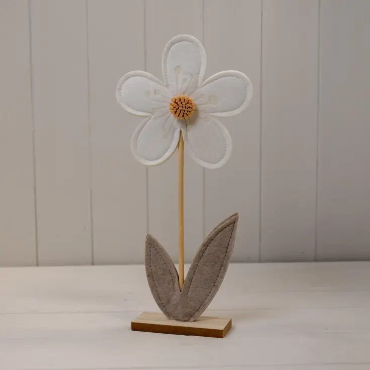 Decorative flower with a wooden base on a plain background
