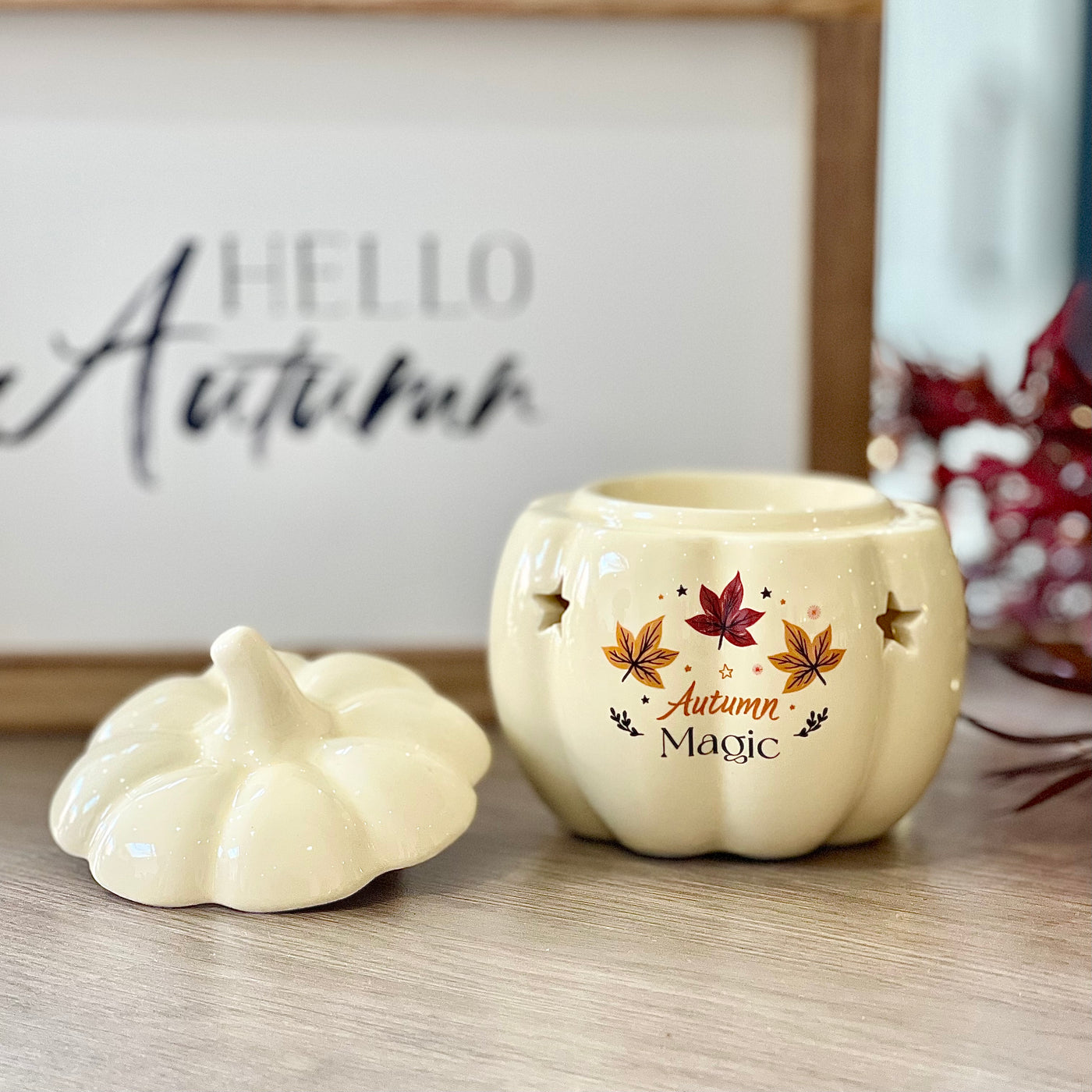 Decorative ceramic pumpkin wax burner with 'Autumn Magic' text and leaf designs