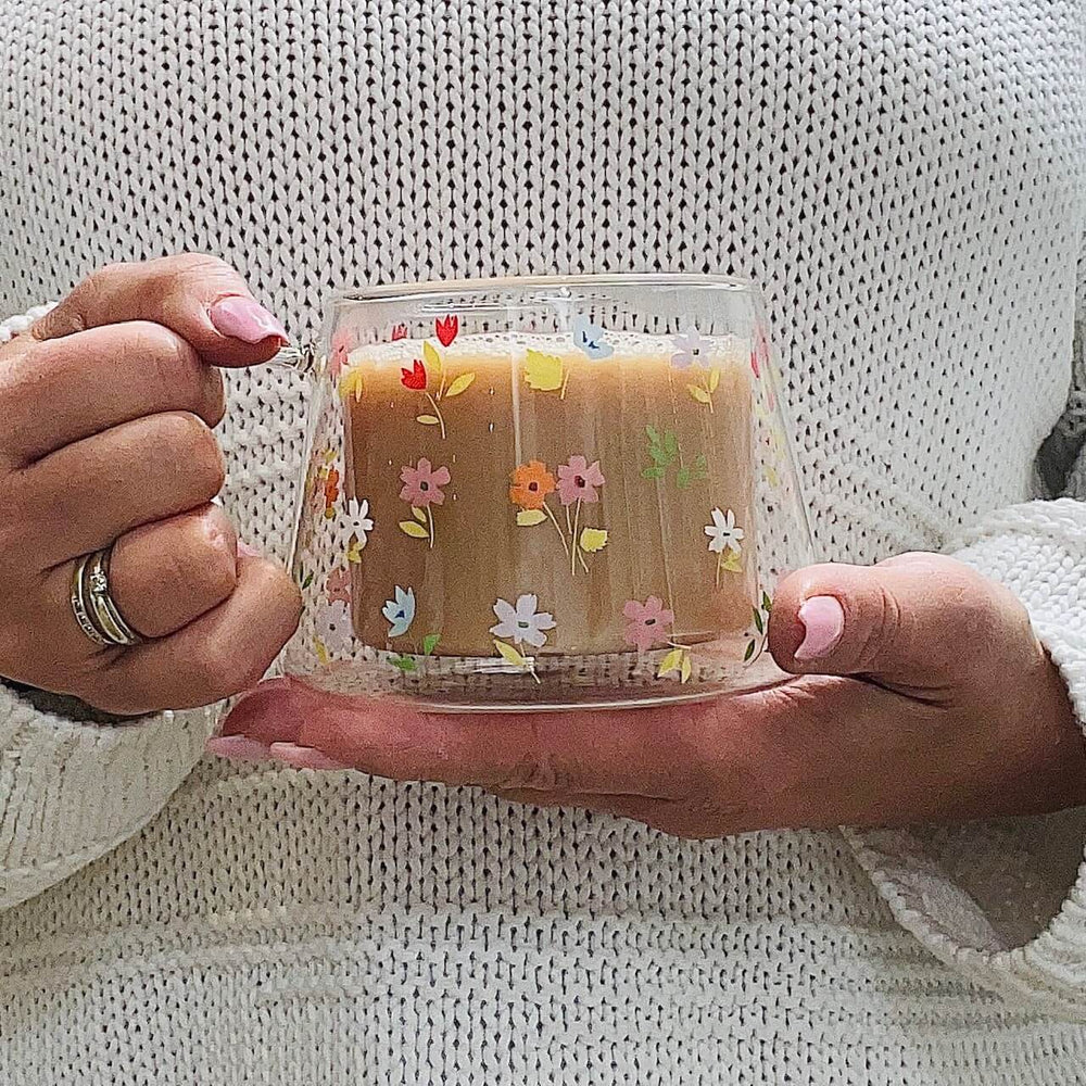 A double Wall Mug with a Tea being held