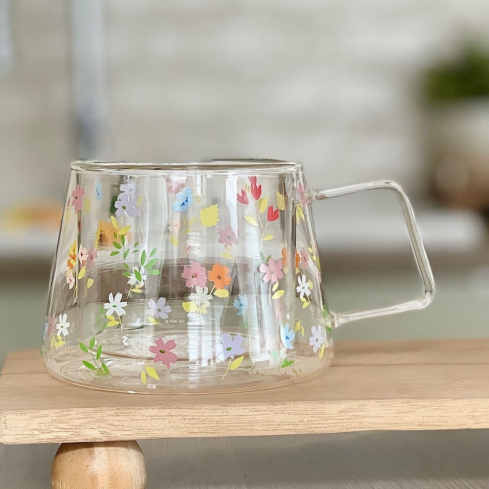 A glass double wall mug with a multi colour summer flower design