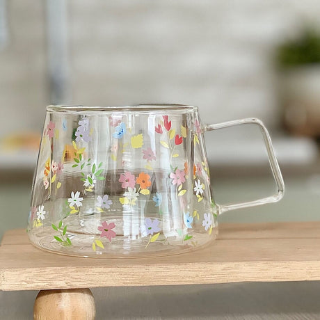 A glass double wall mug with a multi colour summer flower design