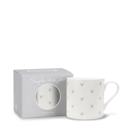 A white fine bone china mug with a pattern of small gray hearts, shown next to its light gray packaging box on a white background.