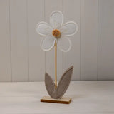Decorative flower with a wooden base on a plain background