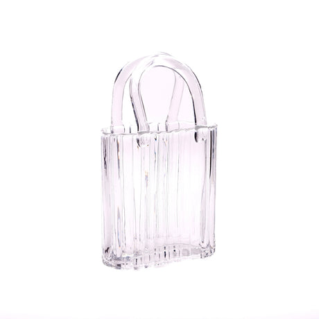 Clear glass handbag vase on a white background