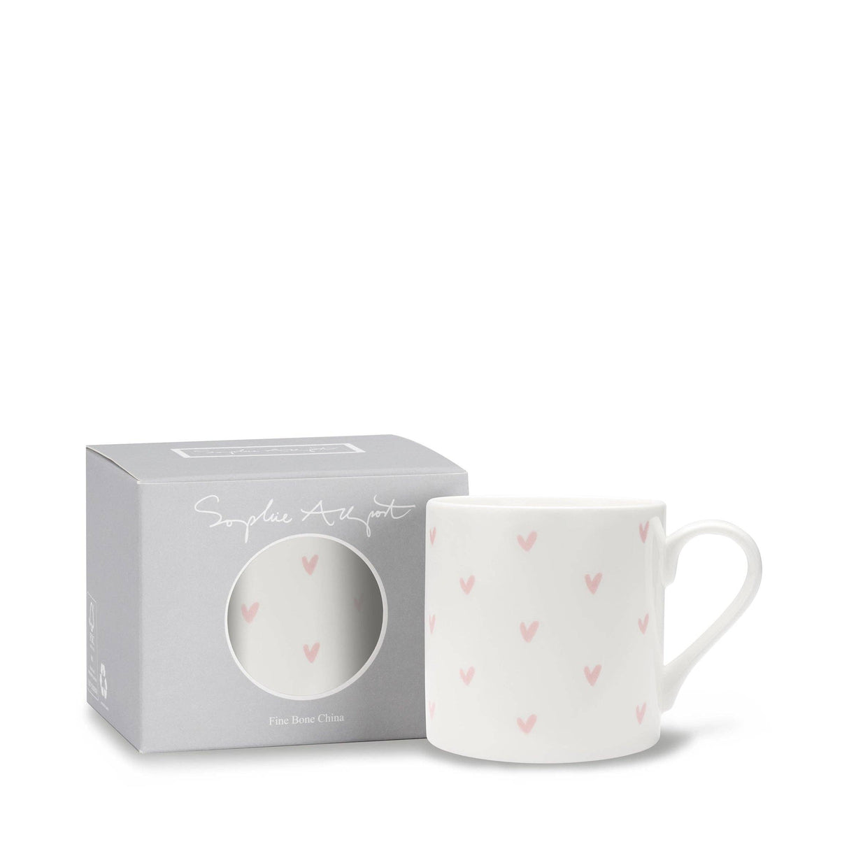 White mug with pink heart patterns in a branded box on a white background